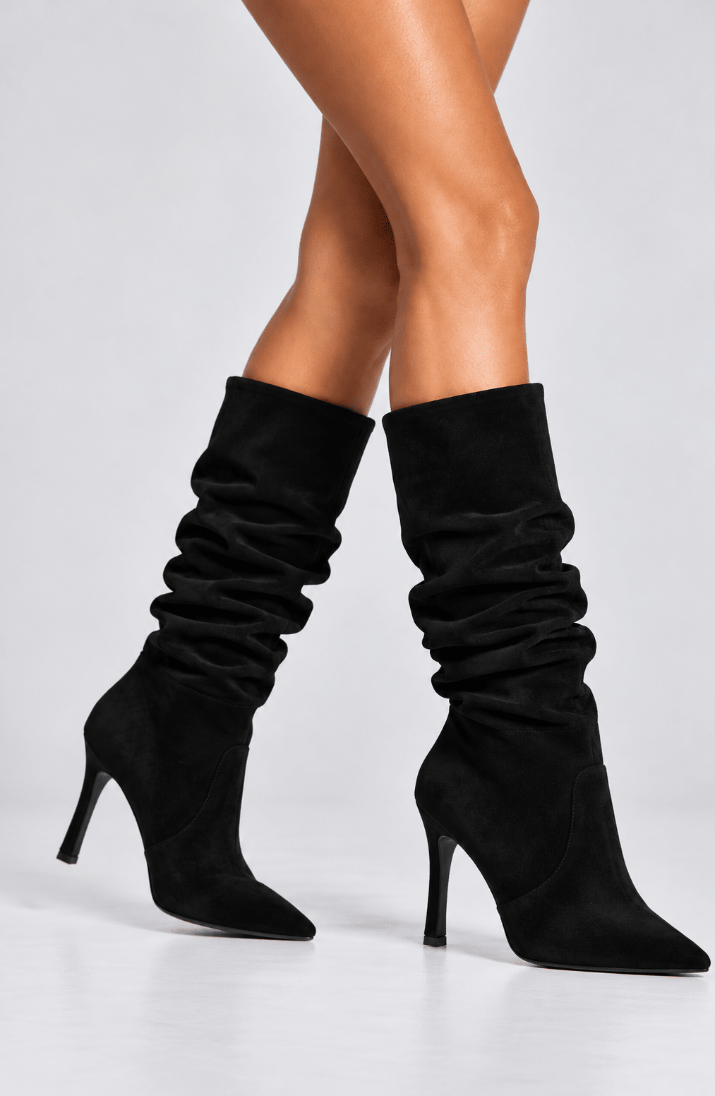 Botas de tacón negro con caña fruncida alta y punta afilada, vista lateral
